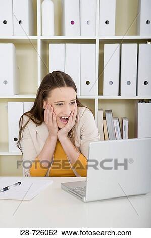 Stock Image - business woman using computer. Fotosearch