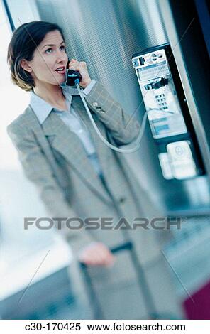 Business woman using public phone View Large Photo Image Stock Photography - Business woman using public phone. Fotosearch