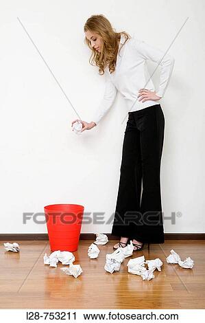 Stock Image - business woman waste paper. Fotosearch