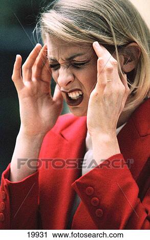 Stock Image - Business woman with headache. Fotosearch