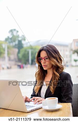 Business woman with laptop in a Cafe View Large Photo Image Stock Photo - Business woman with laptop in a Cafe. Fotosearch