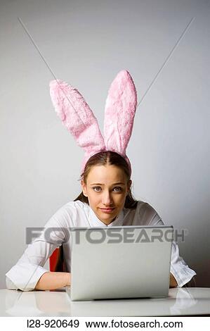 Stock Photo - Business Woman with Rabbit ears. Fotosearch