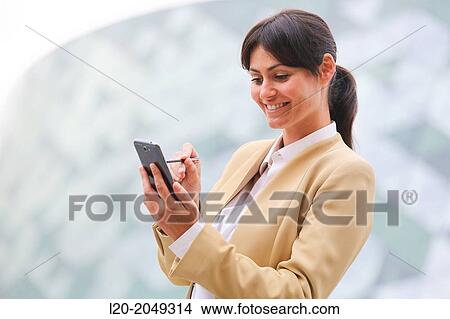 Business woman with smartphone business center. San Sebastian Technology Park. Donostia. Gipuzkoa. Basque Country. Spain. View Large Photo Image Picture - Business woman with smartphone business center. San Sebastian Technology Park. Donostia. Gipuzkoa. Basque Country. Spain.. Fotosearch