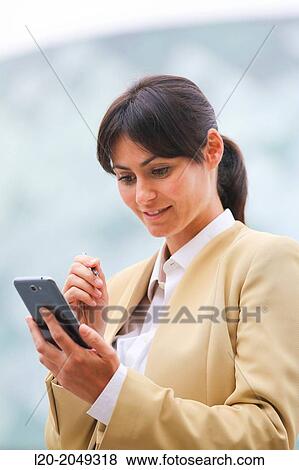 Business woman with smartphone business center. San Sebastian Technology Park. Donostia. Gipuzkoa. Basque Country. Spain. View Large Photo Image Stock Photo - Business woman with smartphone business center. San Sebastian Technology Park. Donostia. Gipuzkoa. Basque Country. Spain.. Fotosearch