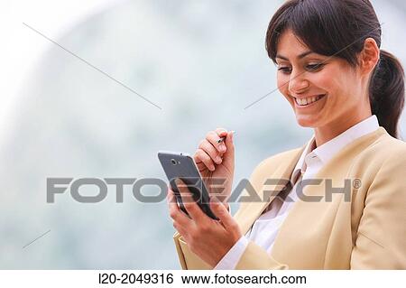 Business woman with smartphone business center. San Sebastian Technology Park. Donostia. Gipuzkoa. Basque Country. Spain. View Large Photo Image Stock Photograph - Business woman with smartphone business center. San Sebastian Technology Park. Donostia. Gipuzkoa. Basque Country. Spain.. Fotosearch
