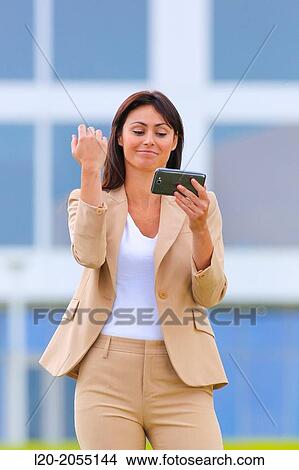 Business woman with smartphone in business center. San Sebastian Technology Park. Donostia. Gipuzkoa. Basque Country. Spain. View Large Photo Image Picture - Business woman with smartphone in business center. San Sebastian Technology Park. Donostia. Gipuzkoa. Basque Country. Spain.. Fotosearch