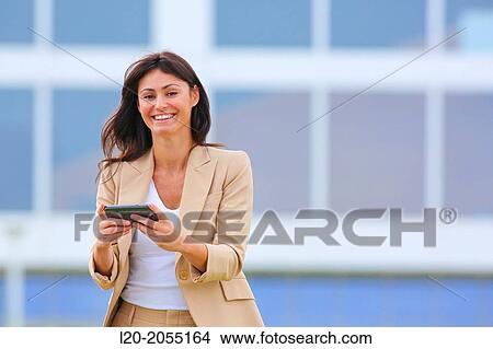 Business woman with smartphone in business center. San Sebastian Technology Park. Donostia. Gipuzkoa. Basque Country. Spain. View Large Photo Image Picture - Business woman with smartphone in business center. San Sebastian Technology Park. Donostia. Gipuzkoa. Basque Country. Spain.. Fotosearch