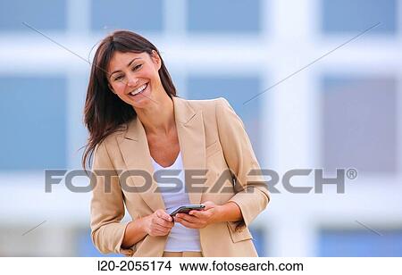 Business woman with smartphone in business center. San Sebastian Technology Park. Donostia. Gipuzkoa. Basque Country. Spain. View Large Photo Image Picture - Business woman with smartphone in business center. San Sebastian Technology Park. Donostia. Gipuzkoa. Basque Country. Spain.. Fotosearch