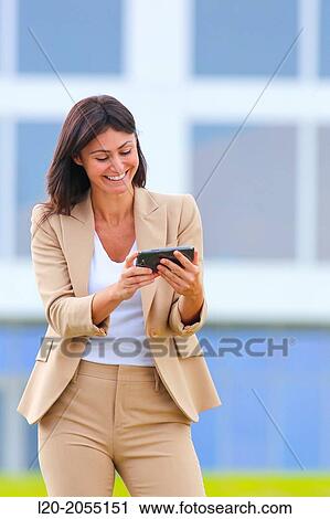 Business woman with smartphone in business center. San Sebastian Technology Park. Donostia. Gipuzkoa. Basque Country. Spain. View Large Photo Image Stock Image - Business woman with smartphone in business center. San Sebastian Technology Park. Donostia. Gipuzkoa. Basque Country. Spain.. Fotosearch