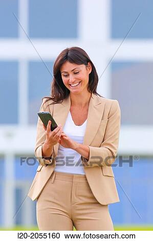 Business woman with smartphone in business center. San Sebastian Technology Park. Donostia. Gipuzkoa. Basque Country. Spain. View Large Photo Image Stock Image - Business woman with smartphone in business center. San Sebastian Technology Park. Donostia. Gipuzkoa. Basque Country. Spain.. Fotosearch