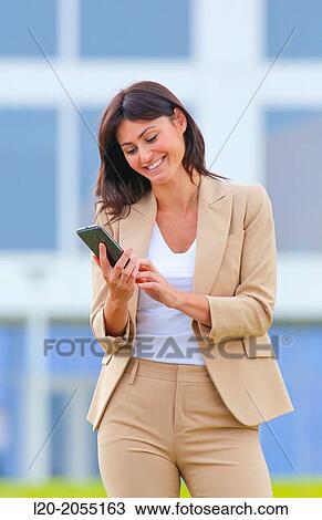Business woman with smartphone in business center. San Sebastian Technology Park. Donostia. Gipuzkoa. Basque Country. Spain. View Large Photo Image Stock Image - Business woman with smartphone in business center. San Sebastian Technology Park. Donostia. Gipuzkoa. Basque Country. Spain.. Fotosearch