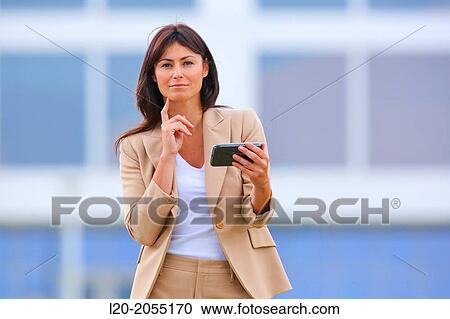 Business woman with smartphone in business center. San Sebastian Technology Park. Donostia. Gipuzkoa. Basque Country. Spain. View Large Photo Image Stock Image - Business woman with smartphone in business center. San Sebastian Technology Park. Donostia. Gipuzkoa. Basque Country. Spain.. Fotosearch