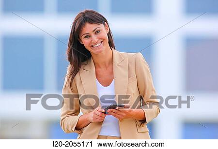 Business woman with smartphone in business center. San Sebastian Technology Park. Donostia. Gipuzkoa. Basque Country. Spain. View Large Photo Image Stock Image - Business woman with smartphone in business center. San Sebastian Technology Park. Donostia. Gipuzkoa. Basque Country. Spain.. Fotosearch