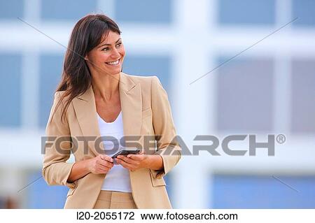Business woman with smartphone in business center. San Sebastian Technology Park. Donostia. Gipuzkoa. Basque Country. Spain. View Large Photo Image Stock Image - Business woman with smartphone in business center. San Sebastian Technology Park. Donostia. Gipuzkoa. Basque Country. Spain.. Fotosearch