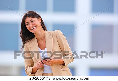 Business woman with smartphone in business center. San Sebastian Technology Park. Donostia. Gipuzkoa. Basque Country. Spain. View Large Photo Image Stock Image - Business woman with smartphone in business center. San Sebastian Technology Park. Donostia. Gipuzkoa. Basque Country. Spain.. Fotosearch