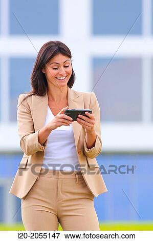 Business woman with smartphone in business center. San Sebastian Technology Park. Donostia. Gipuzkoa. Basque Country. Spain. View Large Photo Image Stock Photo - Business woman with smartphone in business center. San Sebastian Technology Park. Donostia. Gipuzkoa. Basque Country. Spain.. Fotosearch