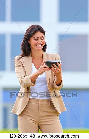 Business woman with smartphone in business center. San Sebastian Technology Park. Donostia. Gipuzkoa. Basque Country. Spain. View Large Photo Image Stock Photo - Business woman with smartphone in business center. San Sebastian Technology Park. Donostia. Gipuzkoa. Basque Country. Spain.. Fotosearch