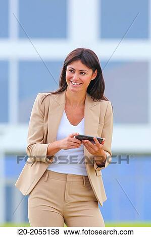 Business woman with smartphone in business center. San Sebastian Technology Park. Donostia. Gipuzkoa. Basque Country. Spain. View Large Photo Image Stock Photo - Business woman with smartphone in business center. San Sebastian Technology Park. Donostia. Gipuzkoa. Basque Country. Spain.. Fotosearch