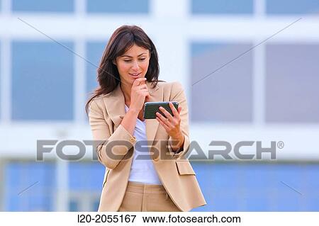 Business woman with smartphone in business center. San Sebastian Technology Park. Donostia. Gipuzkoa. Basque Country. Spain. View Large Photo Image Stock Photo - Business woman with smartphone in business center. San Sebastian Technology Park. Donostia. Gipuzkoa. Basque Country. Spain.. Fotosearch