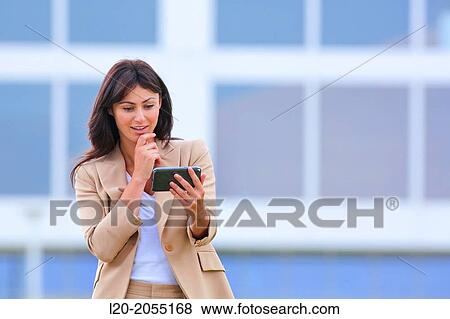 Business woman with smartphone in business center. San Sebastian Technology Park. Donostia. Gipuzkoa. Basque Country. Spain. View Large Photo Image Stock Photo - Business woman with smartphone in business center. San Sebastian Technology Park. Donostia. Gipuzkoa. Basque Country. Spain.. Fotosearch