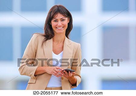 Business woman with smartphone in business center. San Sebastian Technology Park. Donostia. Gipuzkoa. Basque Country. Spain. View Large Photo Image Stock Photo - Business woman with smartphone in business center. San Sebastian Technology Park. Donostia. Gipuzkoa. Basque Country. Spain.. Fotosearch