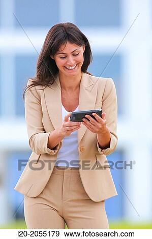 Business woman with smartphone in business center. San Sebastian Technology Park. Donostia. Gipuzkoa. Basque Country. Spain. View Large Photo Image Stock Photo - Business woman with smartphone in business center. San Sebastian Technology Park. Donostia. Gipuzkoa. Basque Country. Spain.. Fotosearch