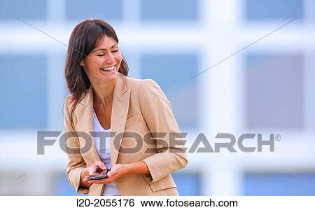Business woman with smartphone in business center. San Sebastian Technology Park. Donostia. Gipuzkoa. Basque Country. Spain. View Large Photo Image Stock Photograph - Business woman with smartphone in business center. San Sebastian Technology Park. Donostia. Gipuzkoa. Basque Country. Spain.. Fotosearch