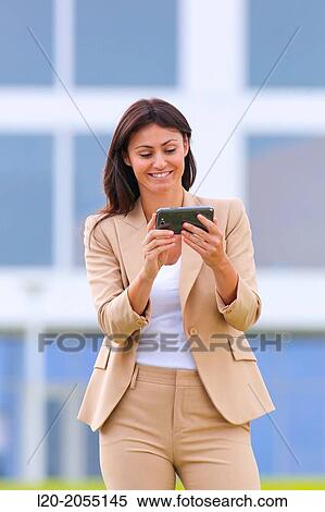 Business woman with smartphone in business center. San Sebastian Technology Park. Donostia. Gipuzkoa. Basque Country. Spain. View Large Photo Image Stock Photography - Business woman with smartphone in business center. San Sebastian Technology Park. Donostia. Gipuzkoa. Basque Country. Spain.. Fotosearch
