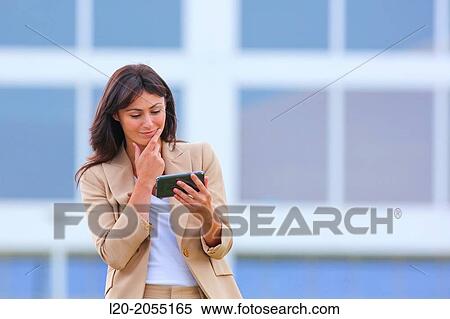 Business woman with smartphone in business center. San Sebastian Technology Park. Donostia. Gipuzkoa. Basque Country. Spain. View Large Photo Image Stock Photography - Business woman with smartphone in business center. San Sebastian Technology Park. Donostia. Gipuzkoa. Basque Country. Spain.. Fotosearch