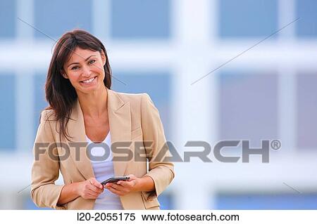 Business woman with smartphone in business center. San Sebastian Technology Park. Donostia. Gipuzkoa. Basque Country. Spain. View Large Photo Image Stock Photography - Business woman with smartphone in business center. San Sebastian Technology Park. Donostia. Gipuzkoa. Basque Country. Spain.. Fotosearch