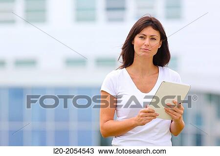 Stock Image - Business woman with tablet in business center. San Sebastian Technology Park. Donostia. Gipuzkoa. Basque Country. Spain.. Fotosearch