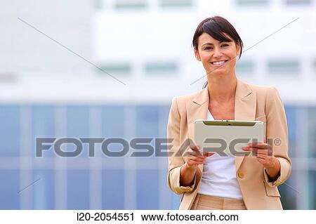Stock Image - Business woman with tablet in business center. San Sebastian Technology Park. Donostia. Gipuzkoa. Basque Country. Spain.. Fotosearch