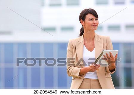 Stock Photo - Business woman with tablet in business center. San Sebastian Technology Park. Donostia. Gipuzkoa. Basque Country. Spain.. Fotosearch
