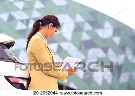Picture - Business woman with tablet in parking business center. San Sebastian Technology Park. Donostia. Gipuzkoa. Basque Country. Spain.. Fotosearch