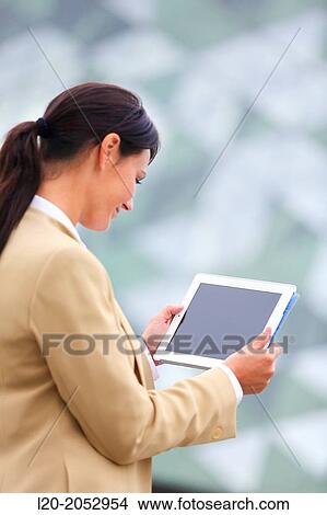 Business woman with tablet in parking business center. San Sebastian Technology Park. Donostia. Gipuzkoa. Basque Country. Spain. View Large Photo Image Picture - Business woman with tablet in parking business center. San Sebastian Technology Park. Donostia. Gipuzkoa. Basque Country. Spain.. Fotosearch