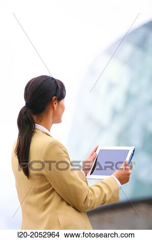 Business woman with tablet in parking business center. San Sebastian Technology Park. Donostia. Gipuzkoa. Basque Country. Spain. View Large Photo Image Picture - Business woman with tablet in parking business center. San Sebastian Technology Park. Donostia. Gipuzkoa. Basque Country. Spain.. Fotosearch