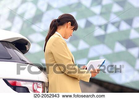 Business woman with tablet in parking business center. San Sebastian Technology Park. Donostia. Gipuzkoa. Basque Country. Spain. View Large Photo Image Stock Image - Business woman with tablet in parking business center. San Sebastian Technology Park. Donostia. Gipuzkoa. Basque Country. Spain.. Fotosearch