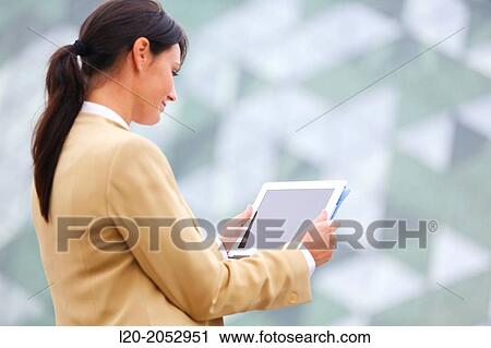 Stock Image - Business woman with tablet in parking business center. San Sebastian Technology Park. Donostia. Gipuzkoa. Basque Country. Spain.. Fotosearch