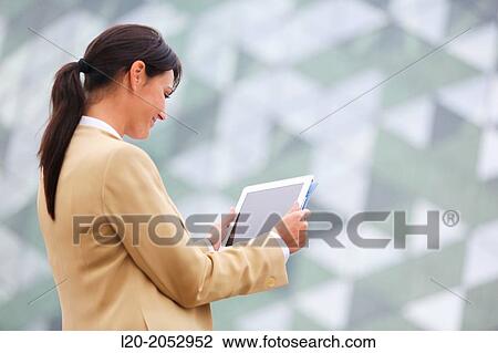 Business woman with tablet in parking business center. San Sebastian Technology Park. Donostia. Gipuzkoa. Basque Country. Spain. View Large Photo Image Stock Image - Business woman with tablet in parking business center. San Sebastian Technology Park. Donostia. Gipuzkoa. Basque Country. Spain.. Fotosearch