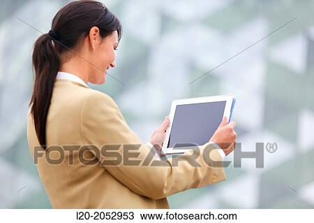 Stock Image - Business woman with tablet in parking business center. San Sebastian Technology Park. Donostia. Gipuzkoa. Basque Country. Spain.. Fotosearch