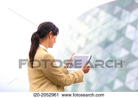 Stock Image - Business woman with tablet in parking business center. San Sebastian Technology Park. Donostia. Gipuzkoa. Basque Country. Spain.. Fotosearch