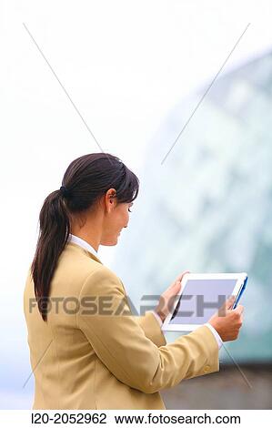 Stock Image - Business woman with tablet in parking business center. San Sebastian Technology Park. Donostia. Gipuzkoa. Basque Country. Spain.. Fotosearch