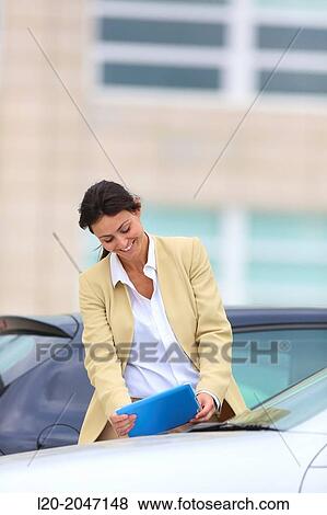 Business woman with tablet in parking business center. San Sebastian Technology Park. Donostia. Gipuzkoa. Basque Country. Spain. View Large Photo Image Stock Photo - Business woman with tablet in parking business center. San Sebastian Technology Park. Donostia. Gipuzkoa. Basque Country. Spain.. Fotosearch