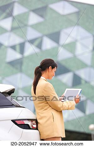 Business woman with tablet in parking business center. San Sebastian Technology Park. Donostia. Gipuzkoa. Basque Country. Spain. View Large Photo Image Stock Photo - Business woman with tablet in parking business center. San Sebastian Technology Park. Donostia. Gipuzkoa. Basque Country. Spain.. Fotosearch