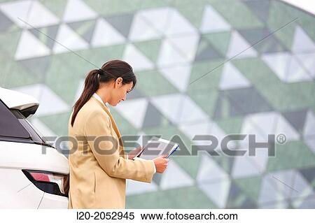 Business woman with tablet in parking business center. San Sebastian Technology Park. Donostia. Gipuzkoa. Basque Country. Spain. View Large Photo Image Stock Photography - Business woman with tablet in parking business center. San Sebastian Technology Park. Donostia. Gipuzkoa. Basque Country. Spain.. Fotosearch