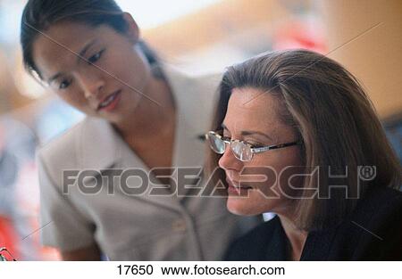 Stock Image - Business women in conference. Fotosearch