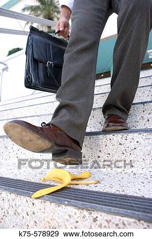 Businessman about to slip on banana peel View Large Photo Image Stock Photo - Businessman about to slip on banana peel. Fotosearch