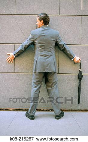 Businessman against the wall View Large Photo Image Stock Photo - Businessman against the wall. Fotosearch