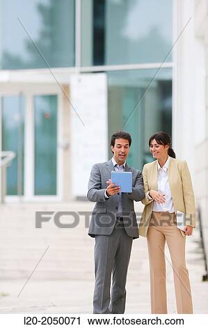 Businessman and business woman with tablet in business center. San Sebastian Technology Park. Donostia. Gipuzkoa. Basque Country. Spain. View Large Photo Image Stock Image - Businessman and business woman with tablet in business center. San Sebastian Technology Park. Donostia. Gipuzkoa. Basque Country. Spain.. Fotosearch