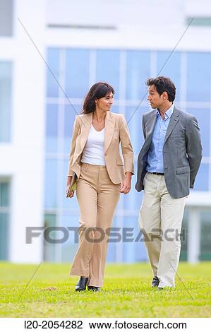 Businessman and businesswoman walking in business center. San Sebastian Technology Park. Donostia. Gipuzkoa. Basque Country. Spain. View Large Photo Image Stock Image - Businessman and businesswoman walking in business center. San Sebastian Technology Park. Donostia. Gipuzkoa. Basque Country. Spain.. Fotosearch
